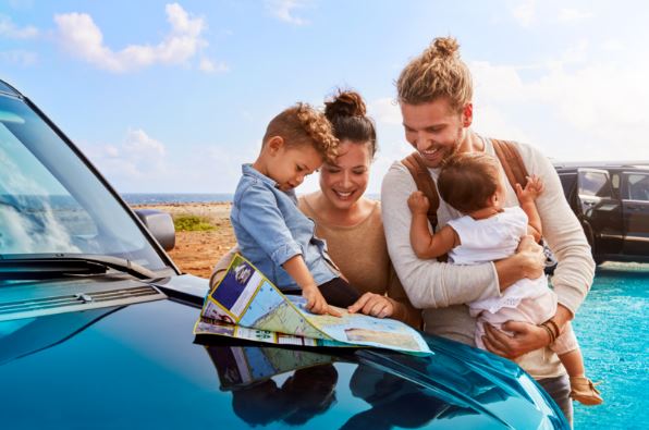 Family with kids looking at map